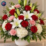 Best Mix Bouquet in Milano with red roses, white lilies, pink carnations and hydrangeas in an elegant white vase.