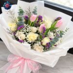 Mix Bouquet 037 with pink tulips, cream roses, white gypsophila, purple statice and white wrapping in Milano.